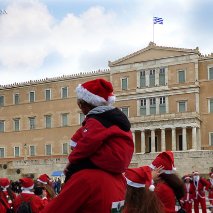 Dad & son runners at the annual Athens Santa run in front of the Greek Parliament - 2016