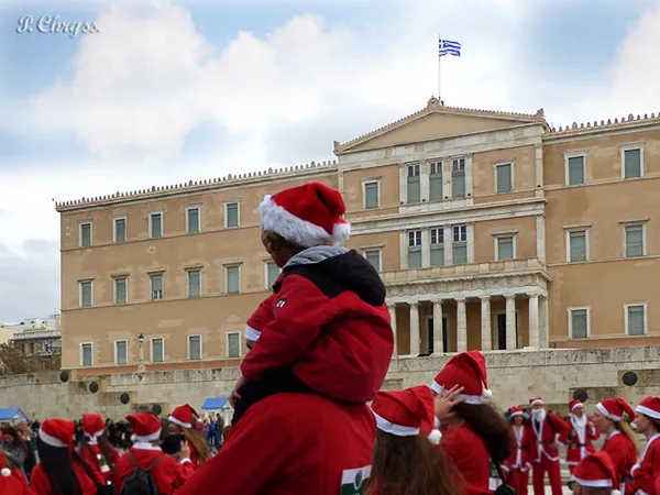 Dad & son runners at the annual Athens Santa run in front of the Greek Parliament - 2016
